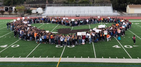 Students forming a large heart on the football field