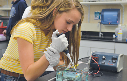 Female student using a micro-pipet 