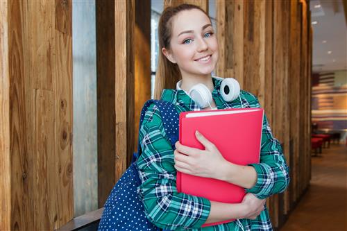 Teen girl with folder smiling 